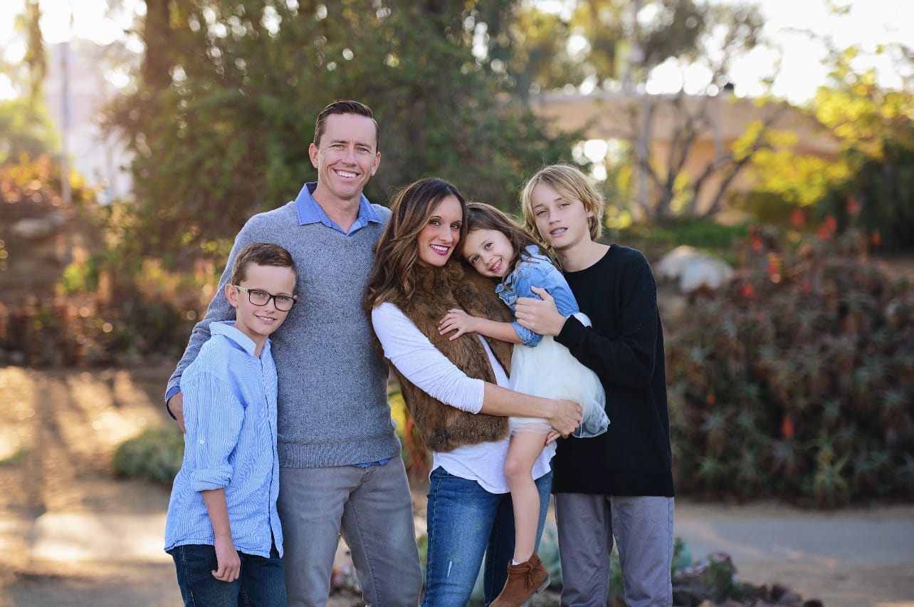 Happy parents with three children.